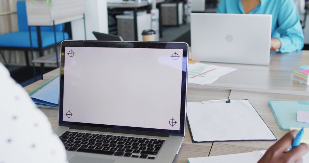 Modern Office Workspace with Laptop Using African American Professionals