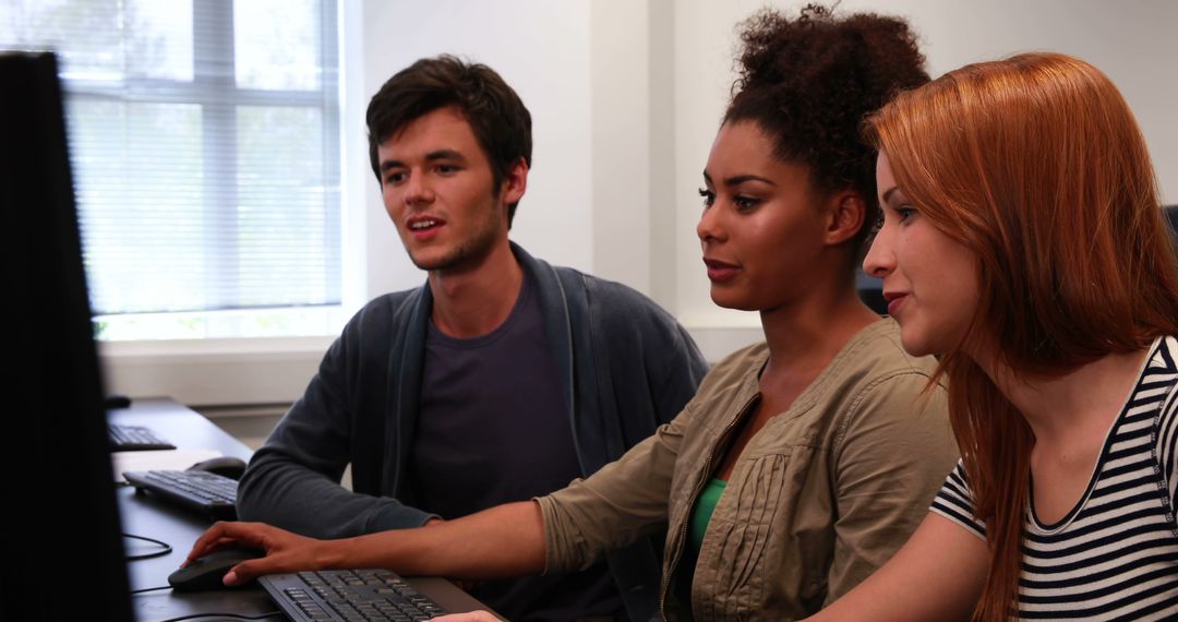 Diverse Colleagues Collaborating on Computer Project in Office