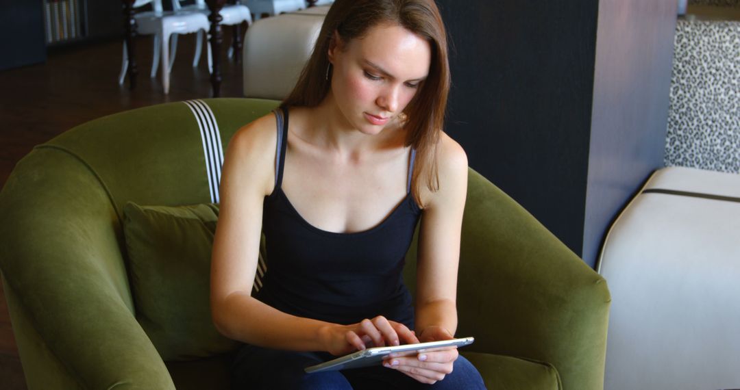 Focused Businesswoman Using Tablet in Modern Workspace