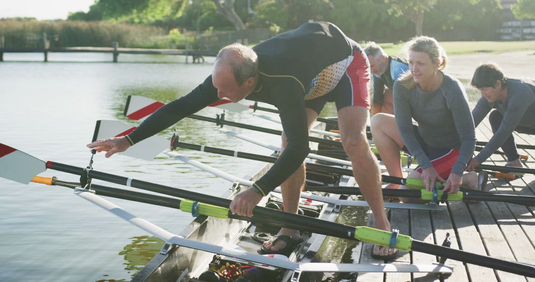 Rowing Team Preparing Boat on Dock for Early Morning Practice - Free Images, Stock Photos and Pictures on Pikwizard.com