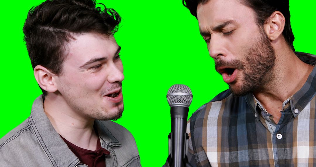 Two Men Singing Together in Front of Green Screen - Free Images, Stock Photos and Pictures on Pikwizard.com