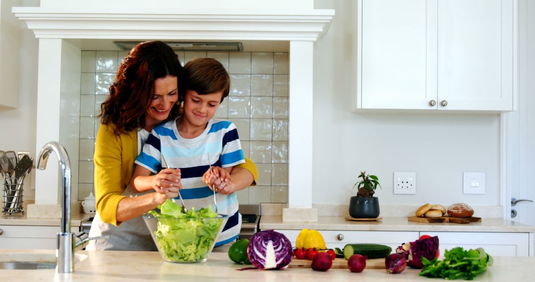 Mother and Son Preparing Salad in Modern Kitchen Together - Free Images, Stock Photos and Pictures on Pikwizard.com