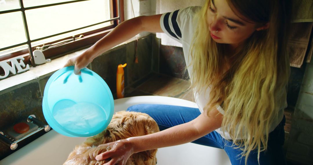 Young Woman Bathing Golden Retriever at Home in Bathtub - Free Images, Stock Photos and Pictures on Pikwizard.com