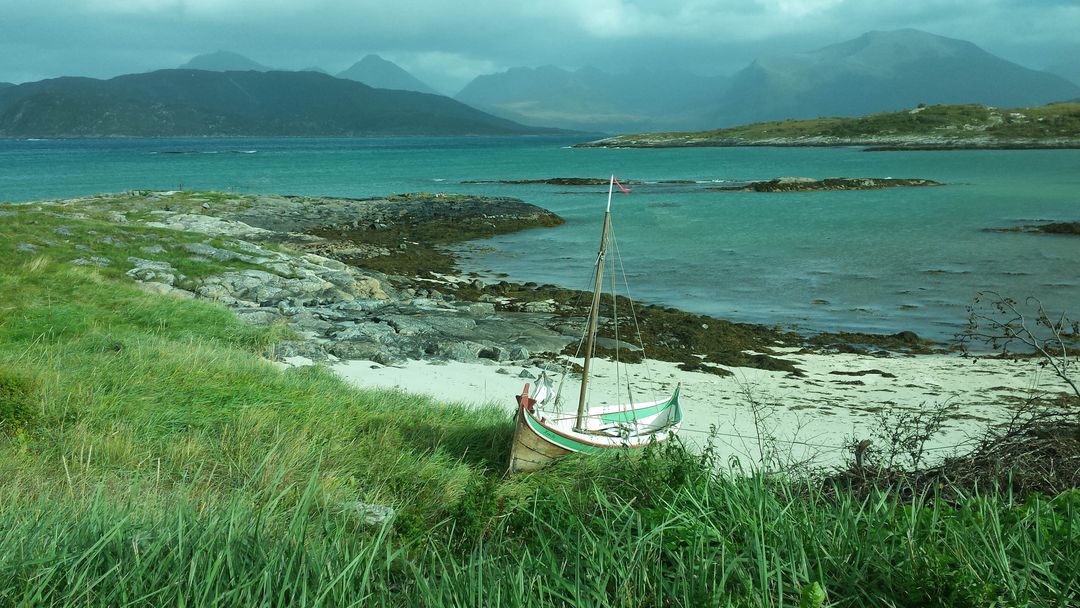 Rustic Wooden Boat on Norwegian Coast Amidst Lush Greenery and Majestic Mountains - Free Images, Stock Photos and Pictures on Pikwizard.com