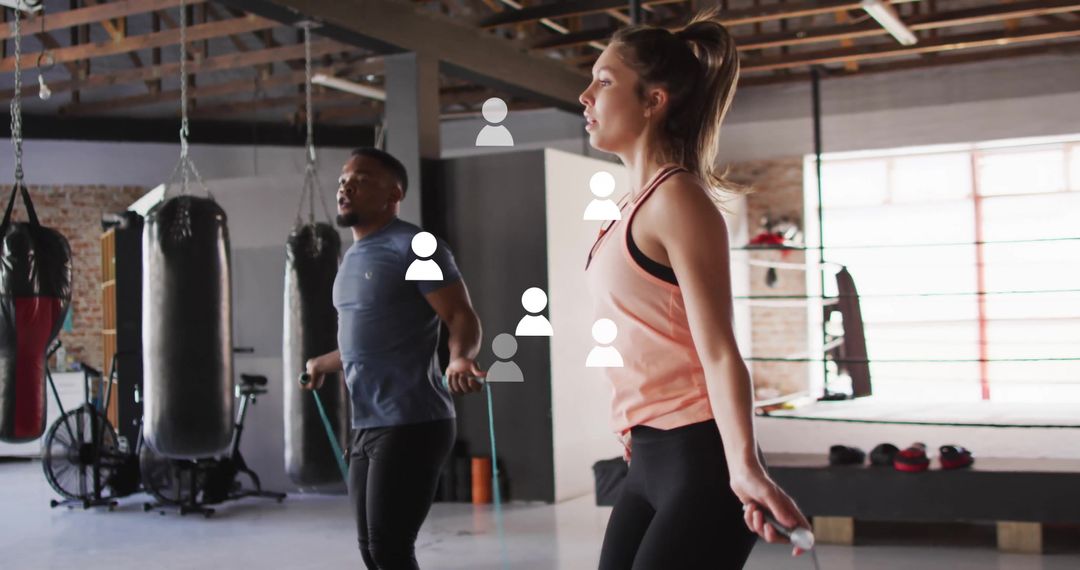 Diverse Athletes Skipping Rope in Modern Gym with Digital Overlay