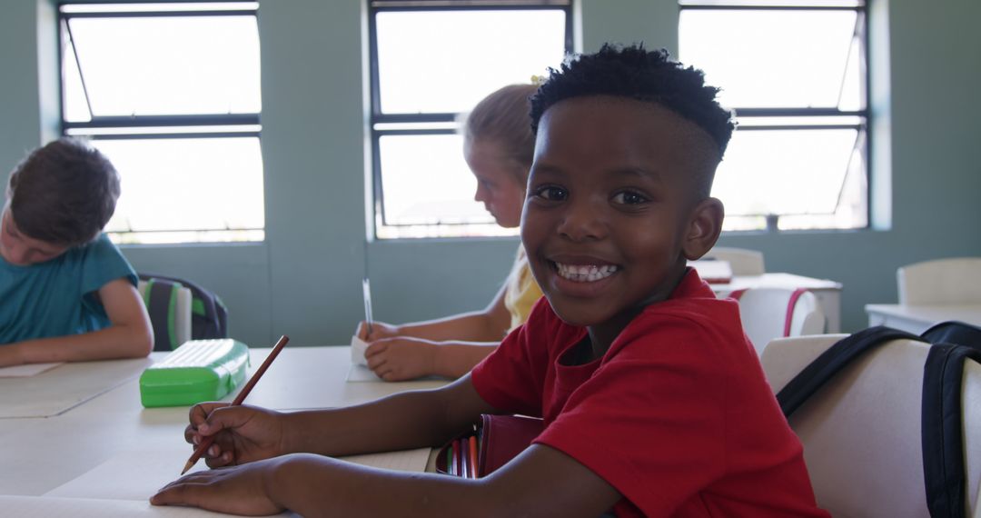 Smiling Boy With Classmates in Classroom Enjoying Learning