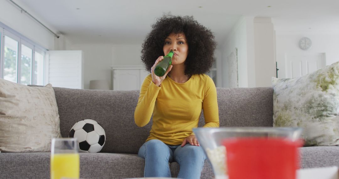 Young Woman Drinking Beer and Watching Football Match at Home - Free Images, Stock Photos and Pictures on Pikwizard.com