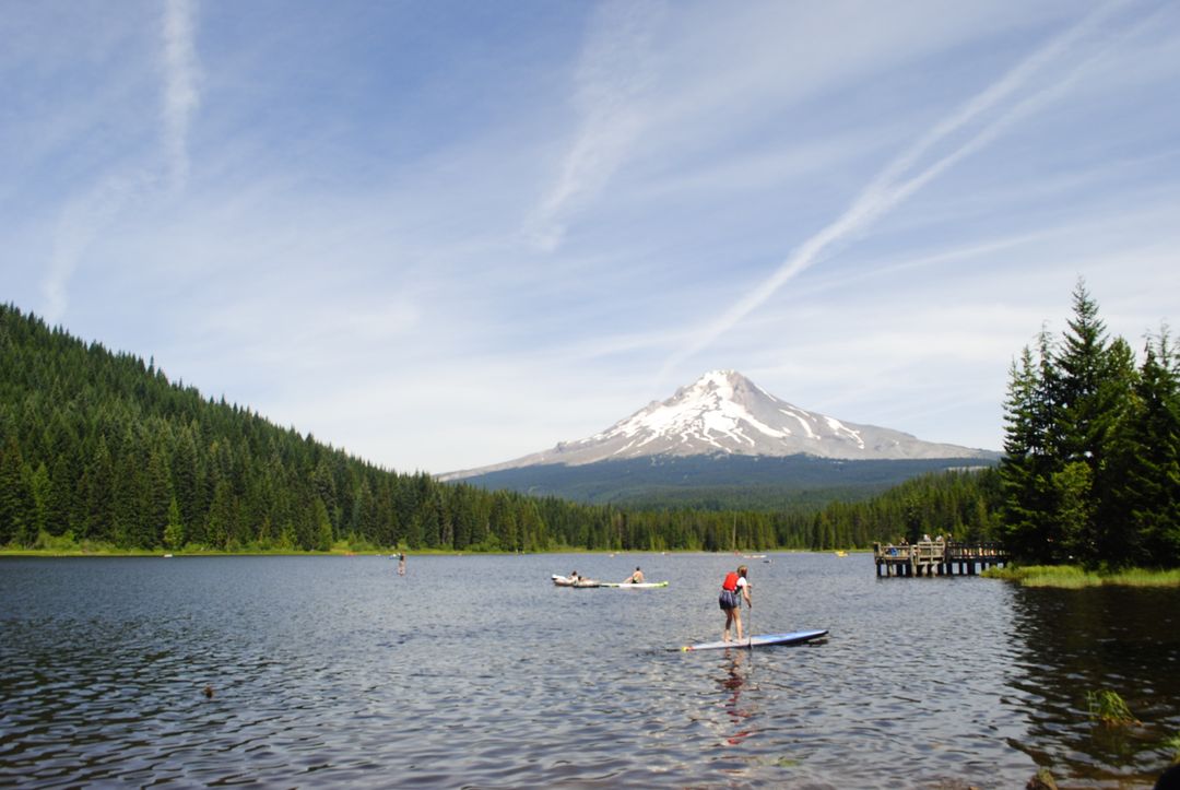 Relaxing Day at a Mountain Lake with Paddle Boarding and Boating - Free Images, Stock Photos and Pictures on Pikwizard.com