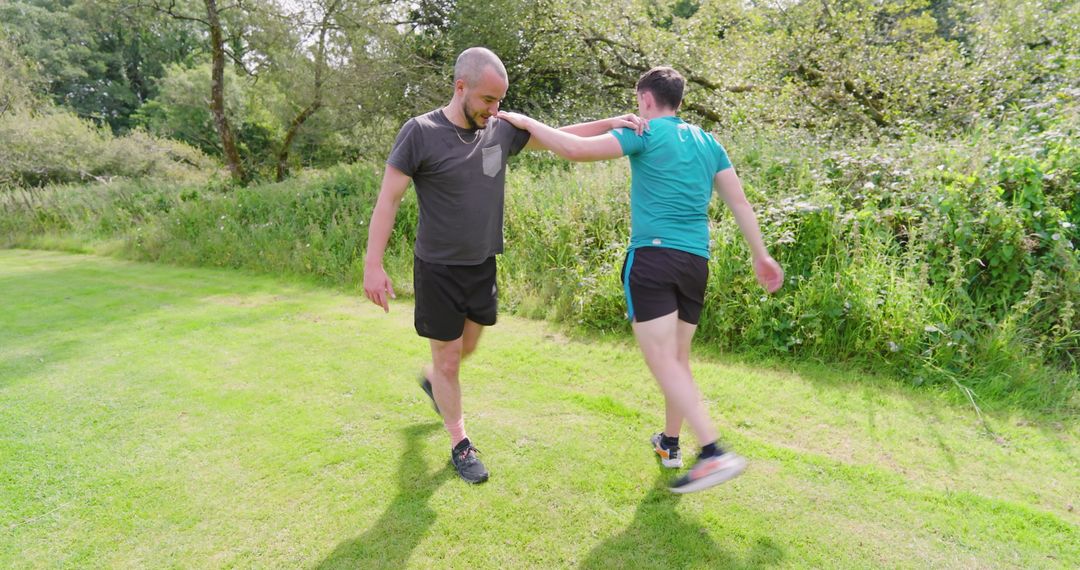 Two Friends Engaging in Playful Outdoor Exercise