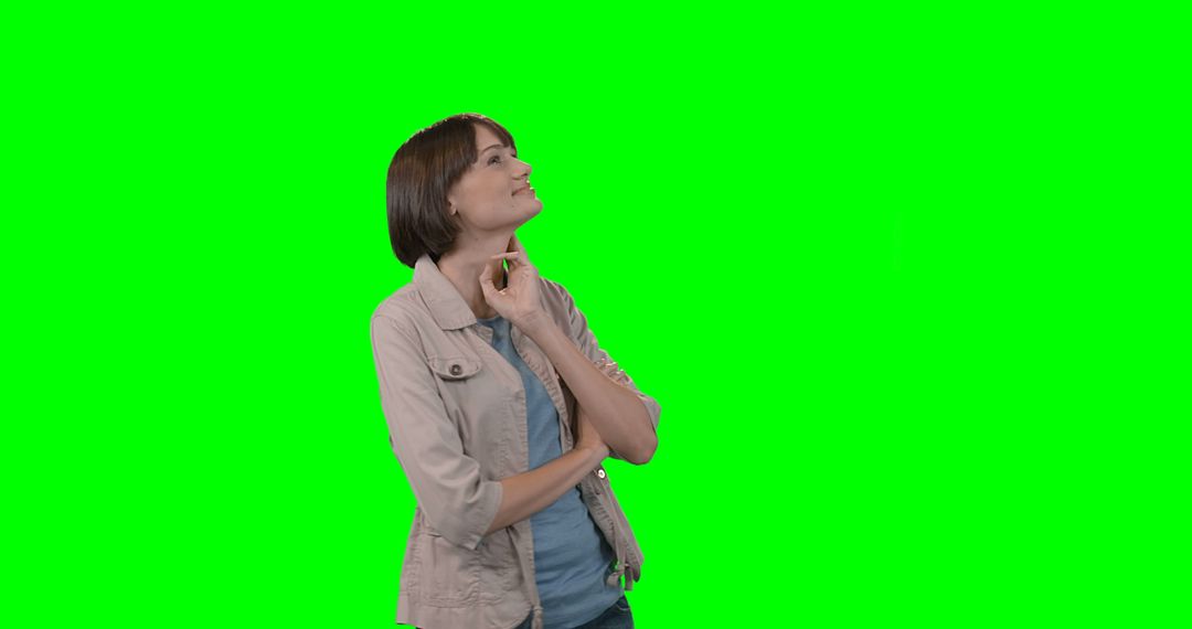 Woman Smiling and Looking Up with Green Screen Background