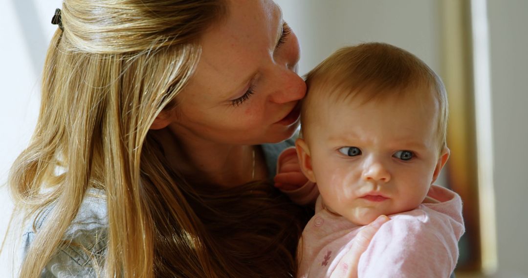 Loving Mother Kissing Baby in Warm Embrace - Free Images, Stock Photos and Pictures on Pikwizard.com