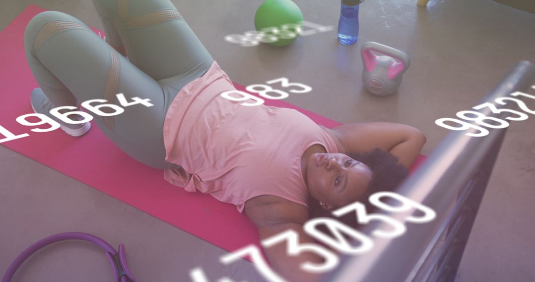 Young Woman Relaxing During Home Workout with Digital Overlay