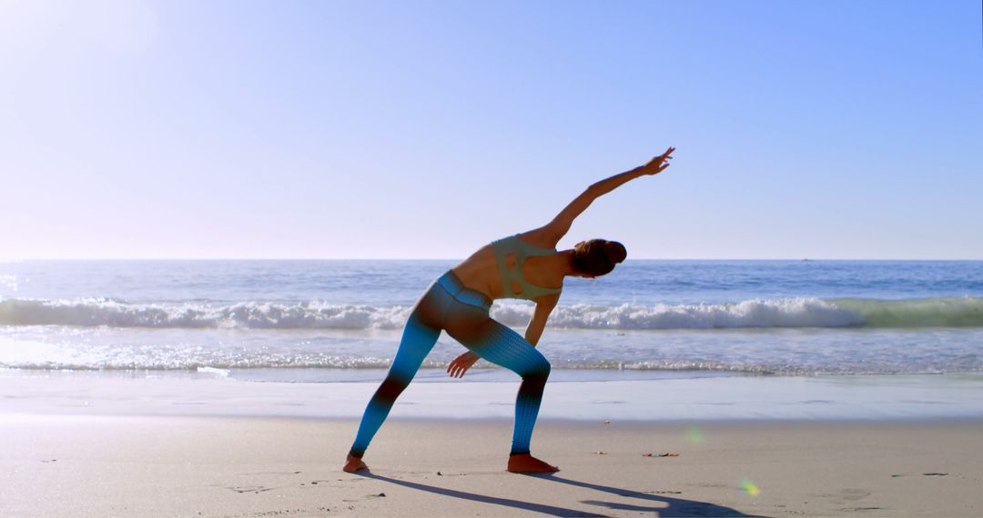 Young Woman Practicing Yoga on a Beach at Sunrise - Free Images, Stock Photos and Pictures on Pikwizard.com