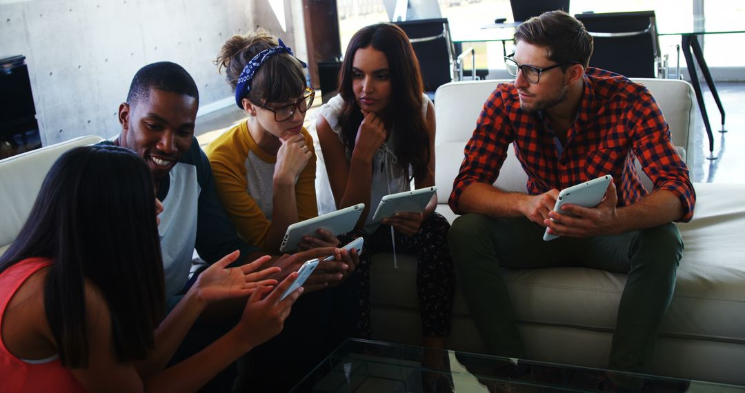 Diverse Young Adults Collaborate Using Tablets in Creative Discussion