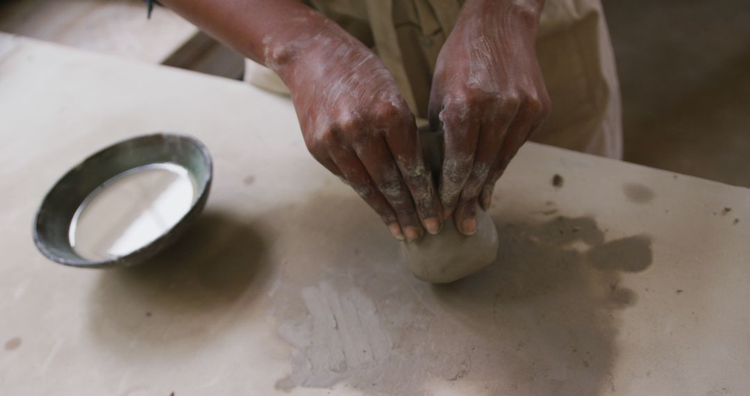 Person Shaping Clay with Hands in Pottery Workshop - Free Images, Stock Photos and Pictures on Pikwizard.com