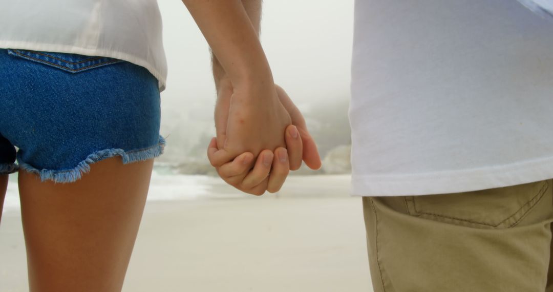 Couple Holding Hands at Beach Enjoying Quality Time