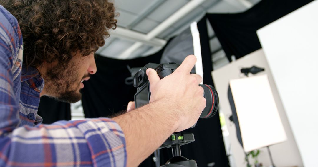 Photographer Focusing Camera in Professional Studio Setup