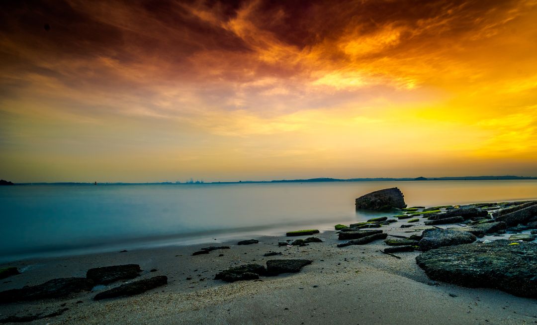 Tranquil Ocean Shore at Sunset with Vibrant Sky