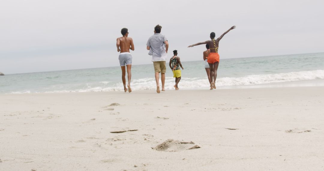 Diverse Friends Joyfully Running on Beach