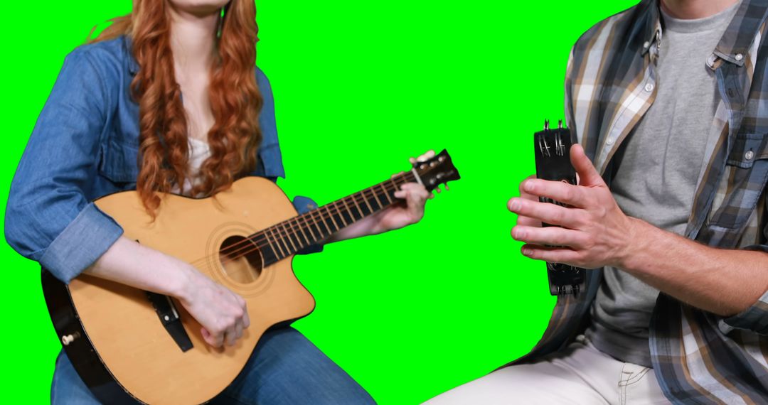 Musicians playing guitar and tambourine against green screen - Free Images, Stock Photos and Pictures on Pikwizard.com