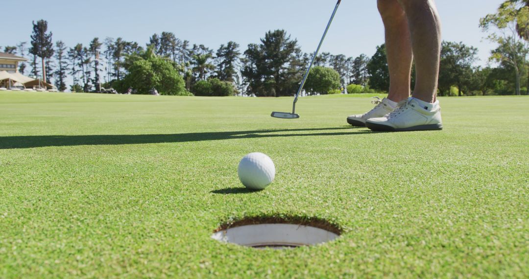 Senior Golfer Preparing Putt on Sunny Day