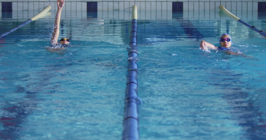 Swimmers Practicing in Indoor Pool Demonstrating Training Focus - Free Images, Stock Photos and Pictures on Pikwizard.com