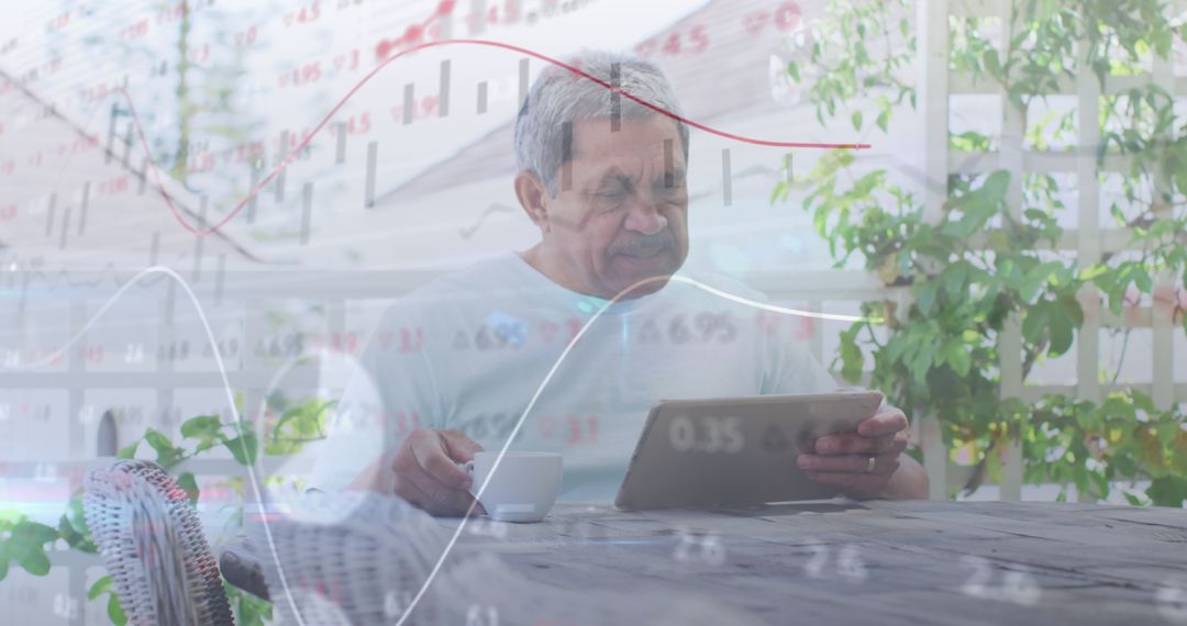Senior Man Analyzing Financial Data at Home on Tablet