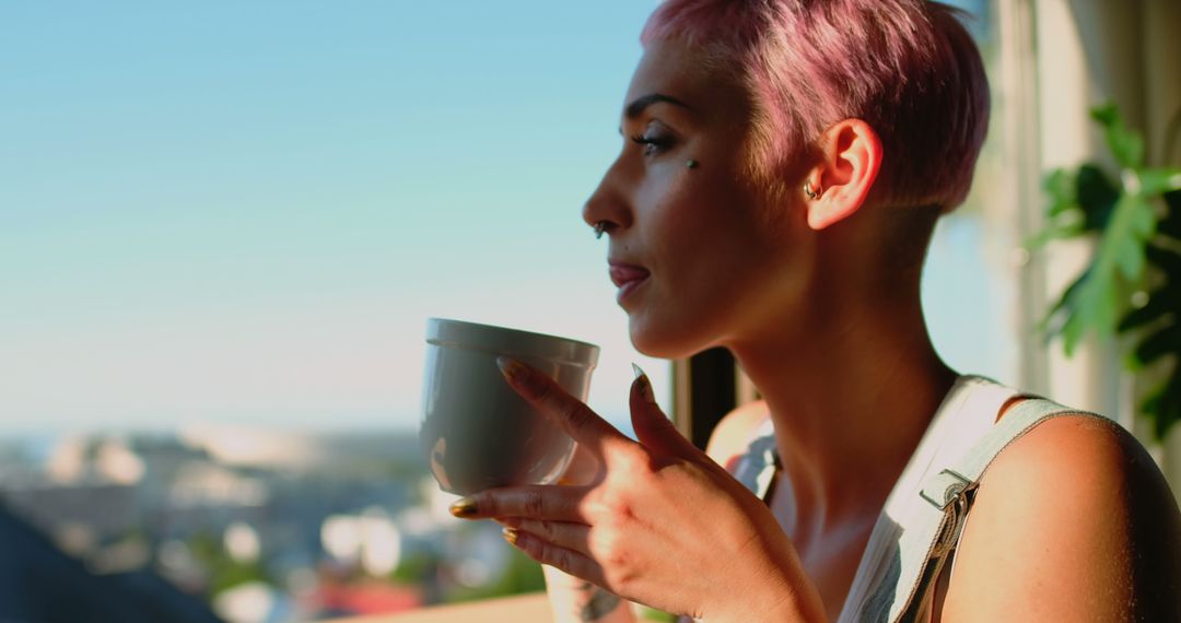 Person with Pink Hair Relaxing and Drinking Coffee by Window - Free Images, Stock Photos and Pictures on Pikwizard.com