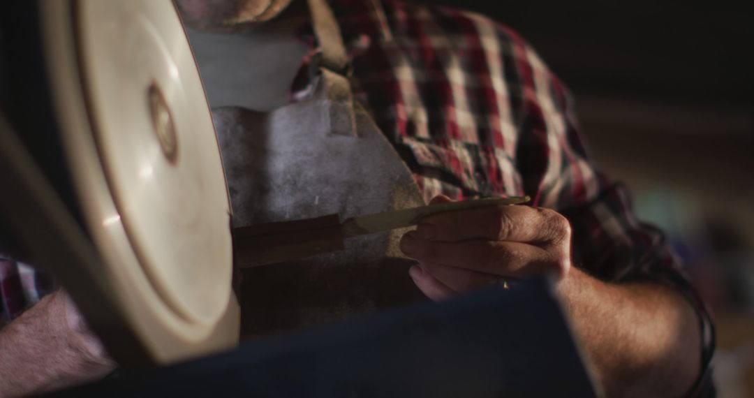 Close-Up of Artisan Sharpening Knife in Workshop - Free Images, Stock Photos and Pictures on Pikwizard.com