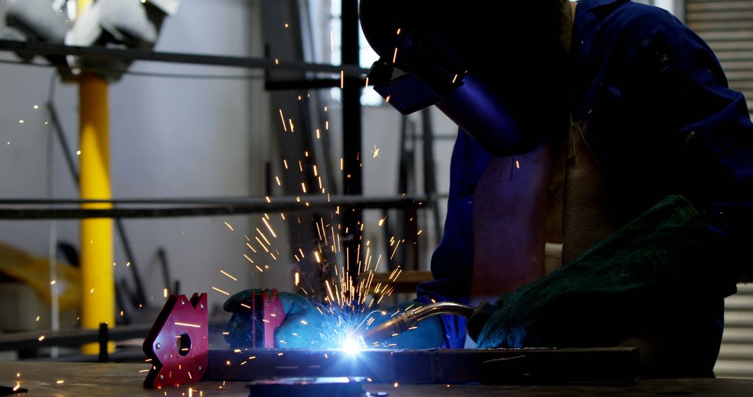 Industrial Worker Welding Metal with Sparks Flying - Free Images, Stock Photos and Pictures on Pikwizard.com