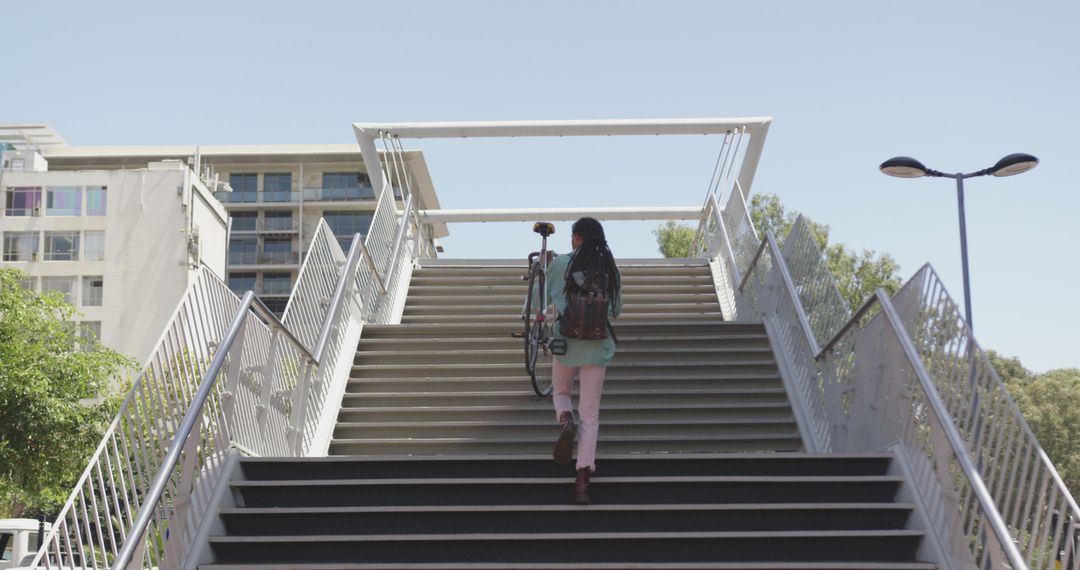 Woman Walking Up Stairs with Bicycle in Urban Area - Free Images, Stock Photos and Pictures on Pikwizard.com