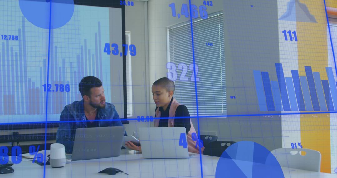 Business Colleagues Analyzing Data with Projection Charts - Free Images, Stock Photos and Pictures on Pikwizard.com