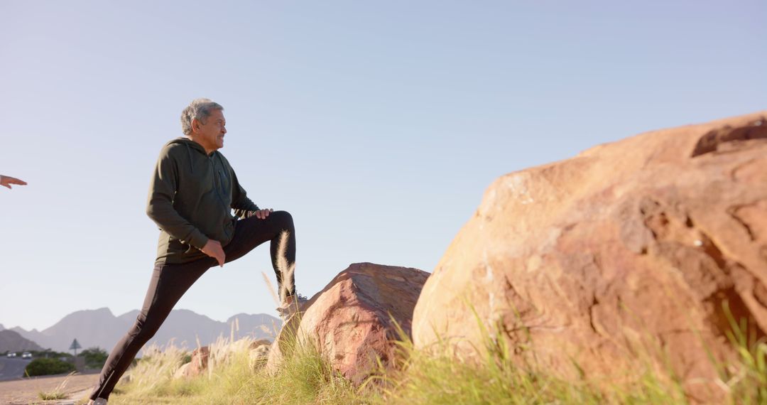 Senior Man Stretching in Desert Enviroment on Sunny Day - Free Images, Stock Photos and Pictures on Pikwizard.com