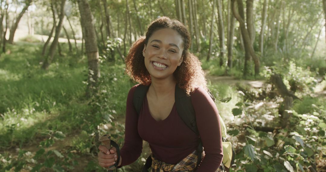 Smiling Young Woman Hiking in Forest - Free Images, Stock Photos and Pictures on Pikwizard.com