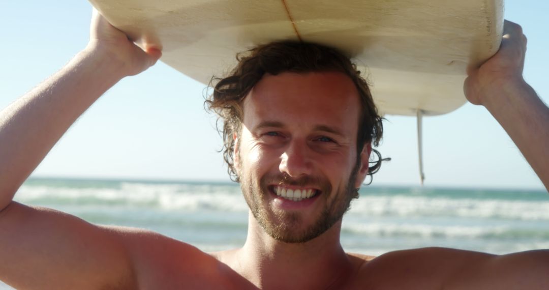 Smiling Young Man Holding Surfboard on Beach - Free Images, Stock Photos and Pictures on Pikwizard.com