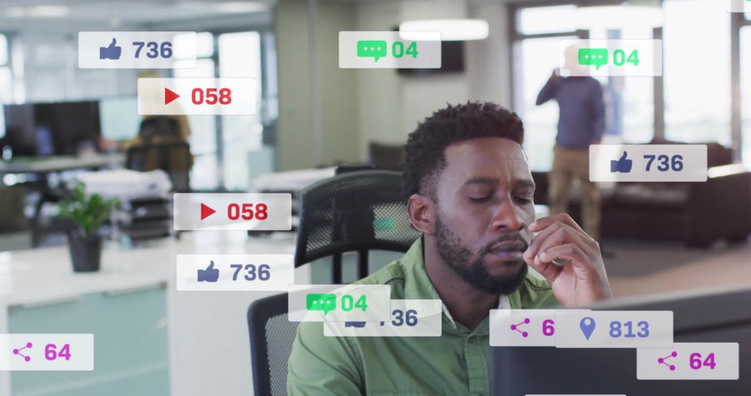Man Multitasking with Social Media Notifications in Modern Office