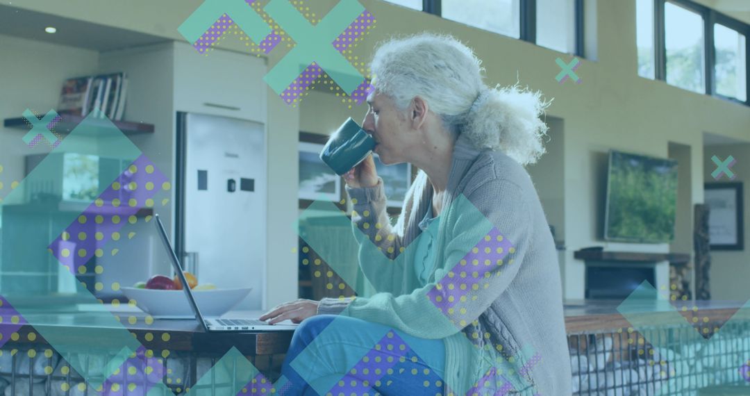 Senior Woman Enjoying Coffee While Using Laptop in Modern Home