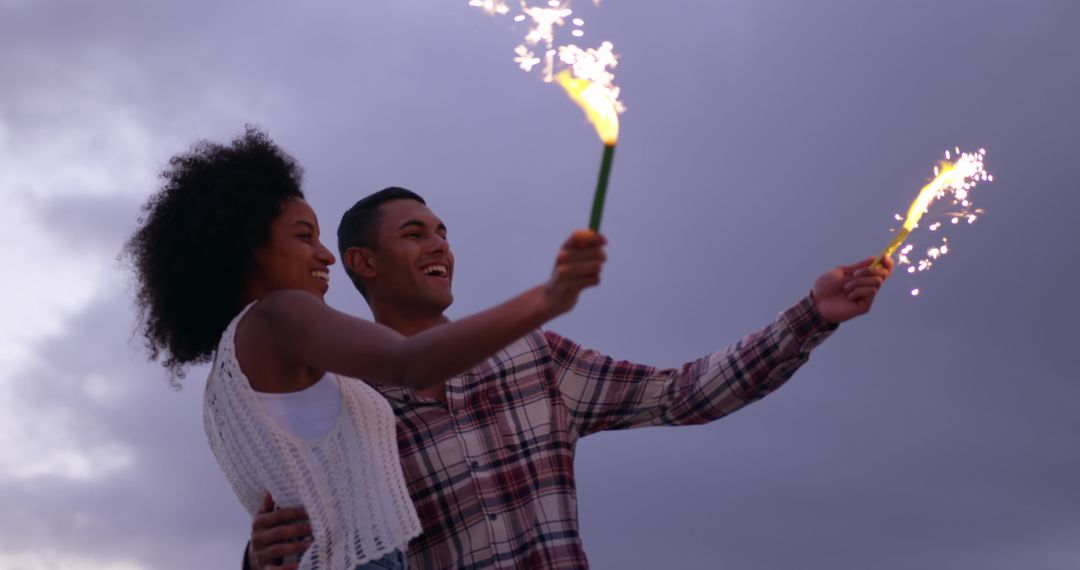 Joyful Couple Celebrating with Sparklers at Dusk