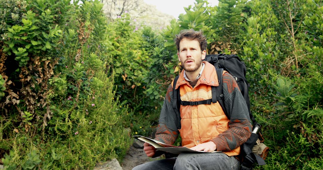 Hiker Navigating On Mountain Trail With Map
