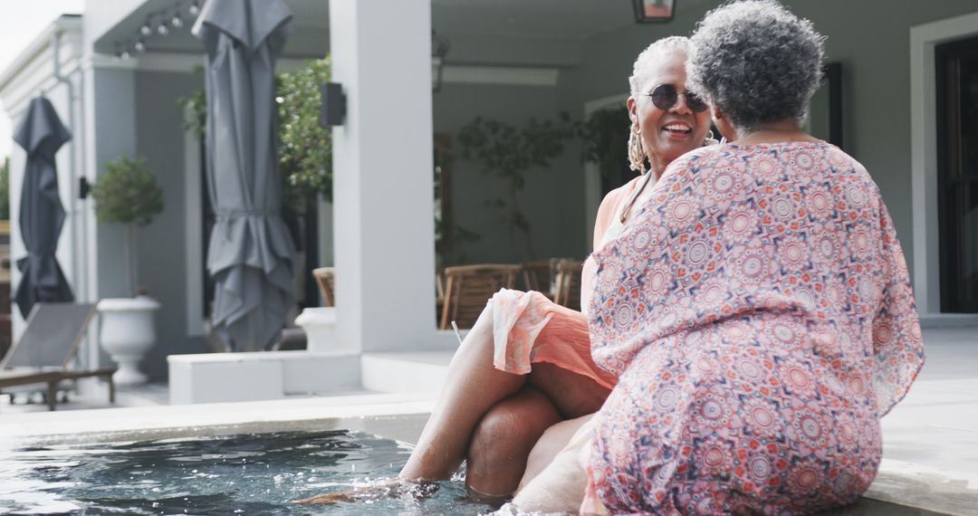Senior Friends Enjoying Sunny Poolside Conversation