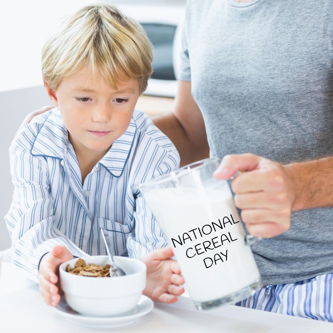 Young Boy and Father Celebrate National Cereal Day at Breakfast Table