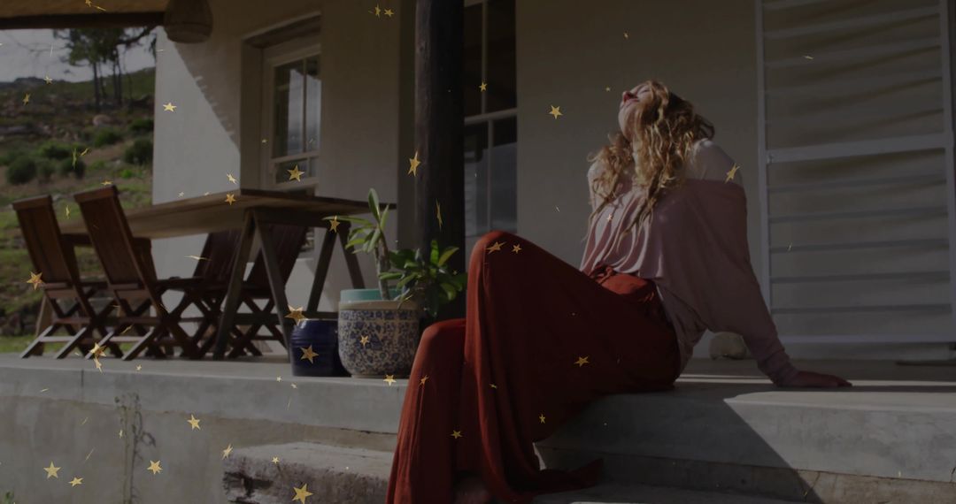 Woman Relaxing on Porch Under Warm Sunlight