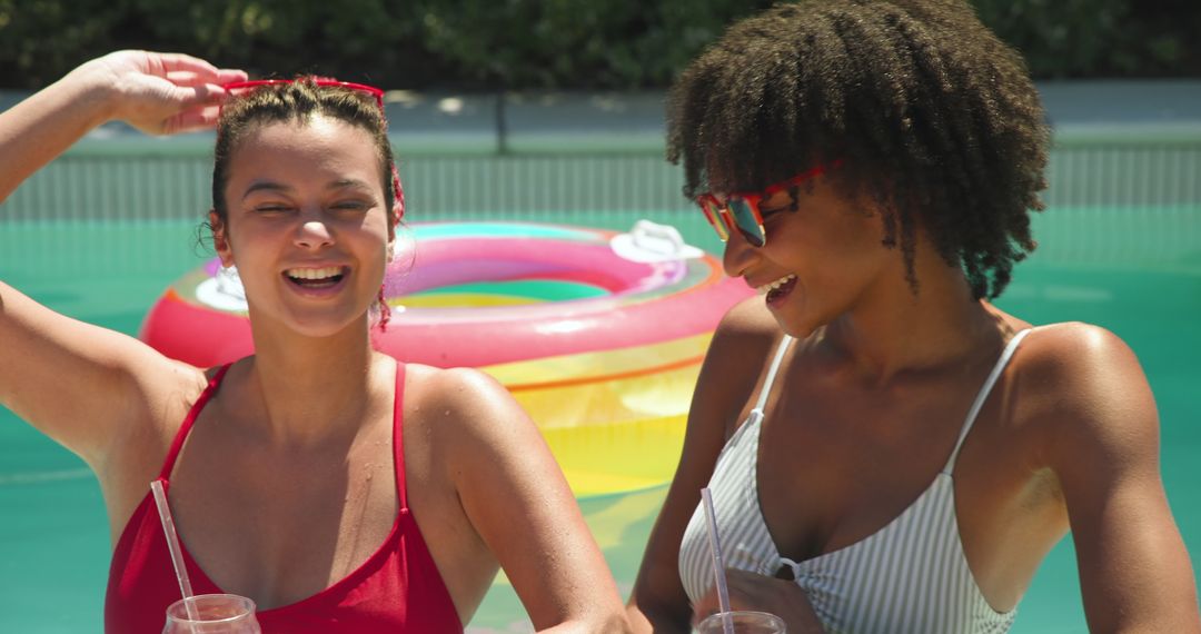 Two Friends Enjoying Relaxing Pool Day with Refreshing Drinks
