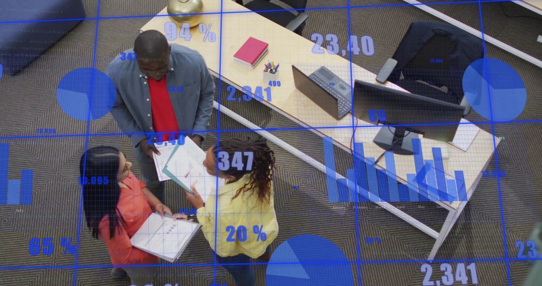 Diverse Team Discussing Data in Modern Office with Digital Charts Overlay