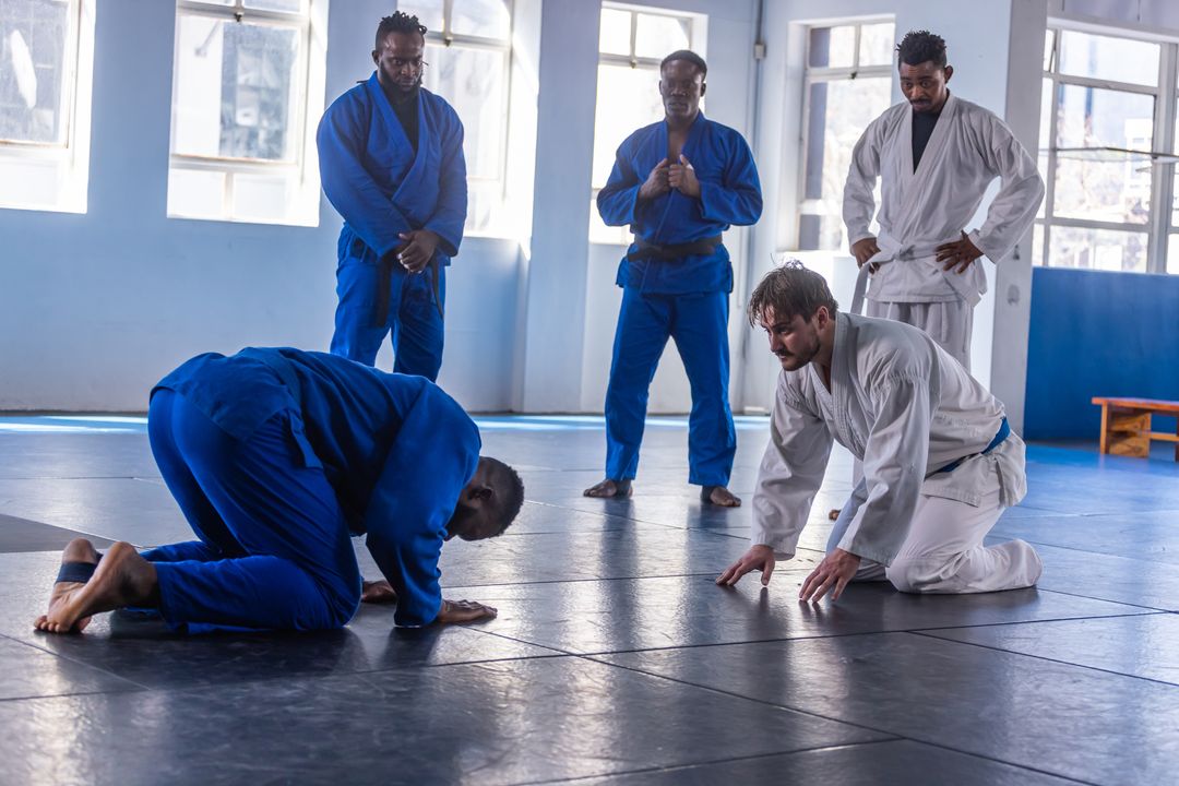 Male Classmates Practicing Martial Arts Techniques in Dojo