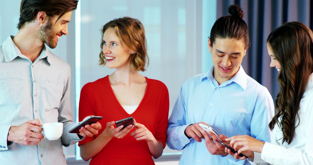 Diverse Colleagues Collaborating with Smartphones in Modern Office