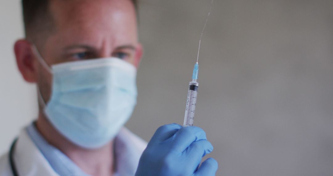 Healthcare Professional Preparing Vaccine Dose with Syringe - Free Images, Stock Photos and Pictures on Pikwizard.com