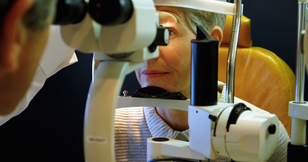 Optometrist Conducting Eye Examination on Senior Woman with Modern Equipment - Free Images, Stock Photos and Pictures on Pikwizard.com