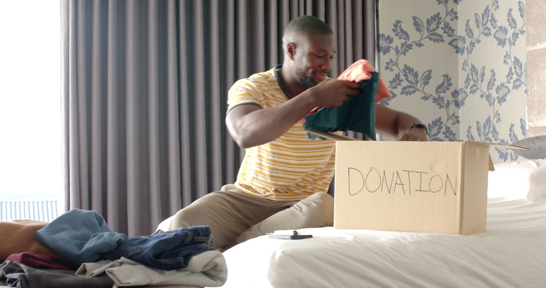 Man Donating Clothes Thoughtfully Organizing Wardrobe Donation