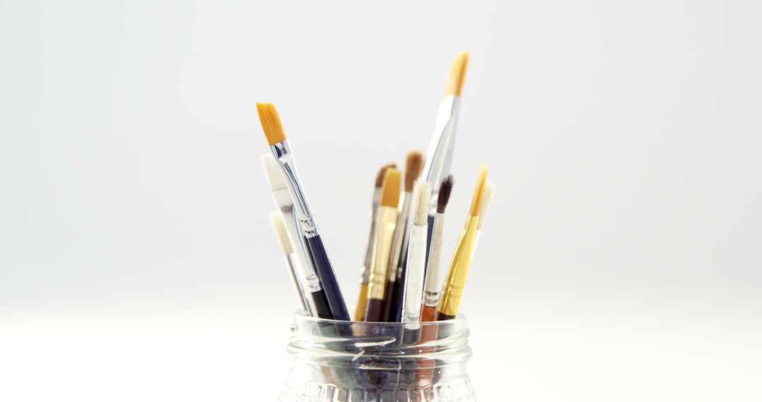 Assorted Paintbrushes in Clear Glass Jar on White Background - Free Images, Stock Photos and Pictures on Pikwizard.com